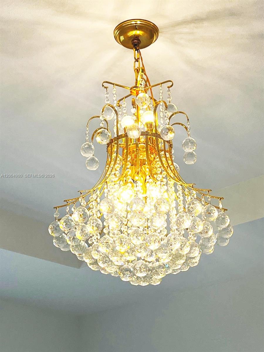 A gold-toned crystal chandelier hangs from a white ceiling — 833 SE 26th Rd # 0, Homestead FL 33035, HOMESTEAD, FL