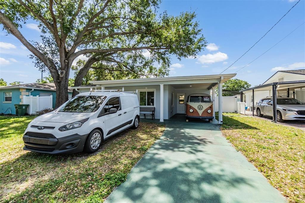 A single-story house with a carport, a white work van, and a vintage Volkswagen bus — 2808 W LAKE AVENUE, TAMPA, FL