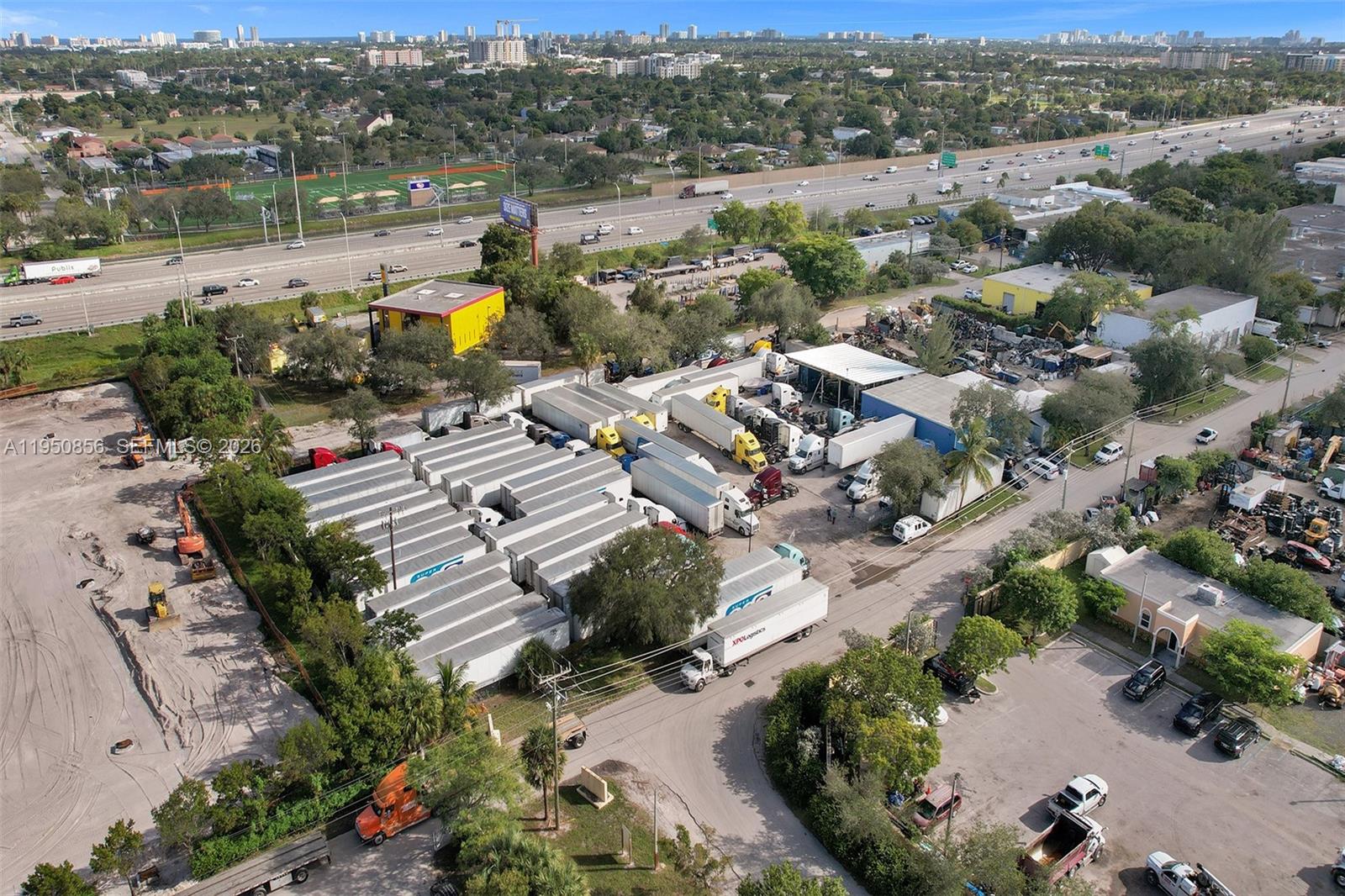 An aerial view shows a commercial trucking yard with numerous trailers and vehicles near a highway — 850 NW 12th Ter, Pompano Beach FL 33069, POMPANO BEACH, FL