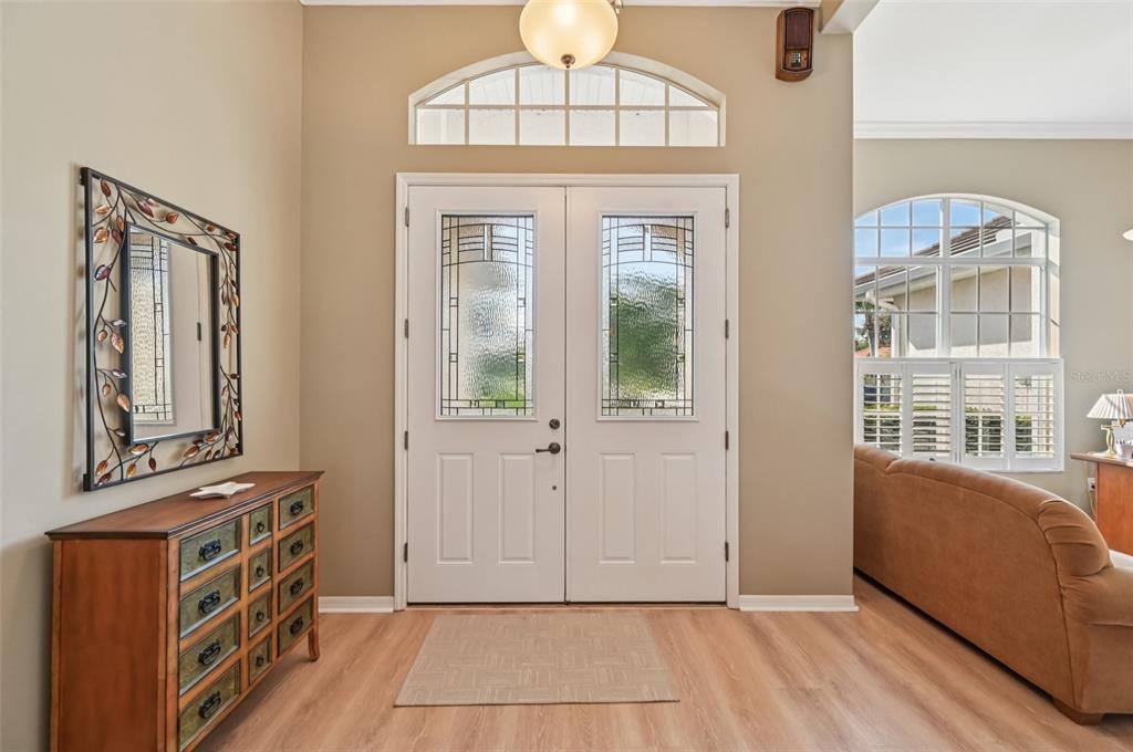 A foyer features double front doors with glass inserts, a wood dresser, and light flooring — 514 SUMMERFIELD WAY, VENICE, FL