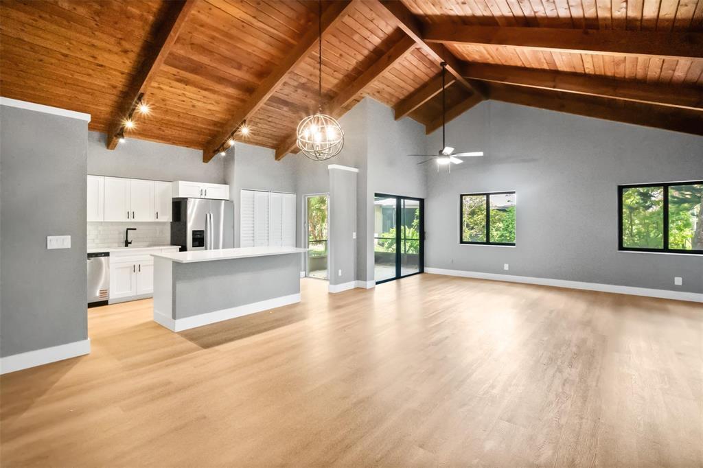 A bright, open-concept kitchen and living area features vaulted wood ceilings and light flooring — 2146 Nova Village Drive, Davie FL 33317, DAVIE, FL