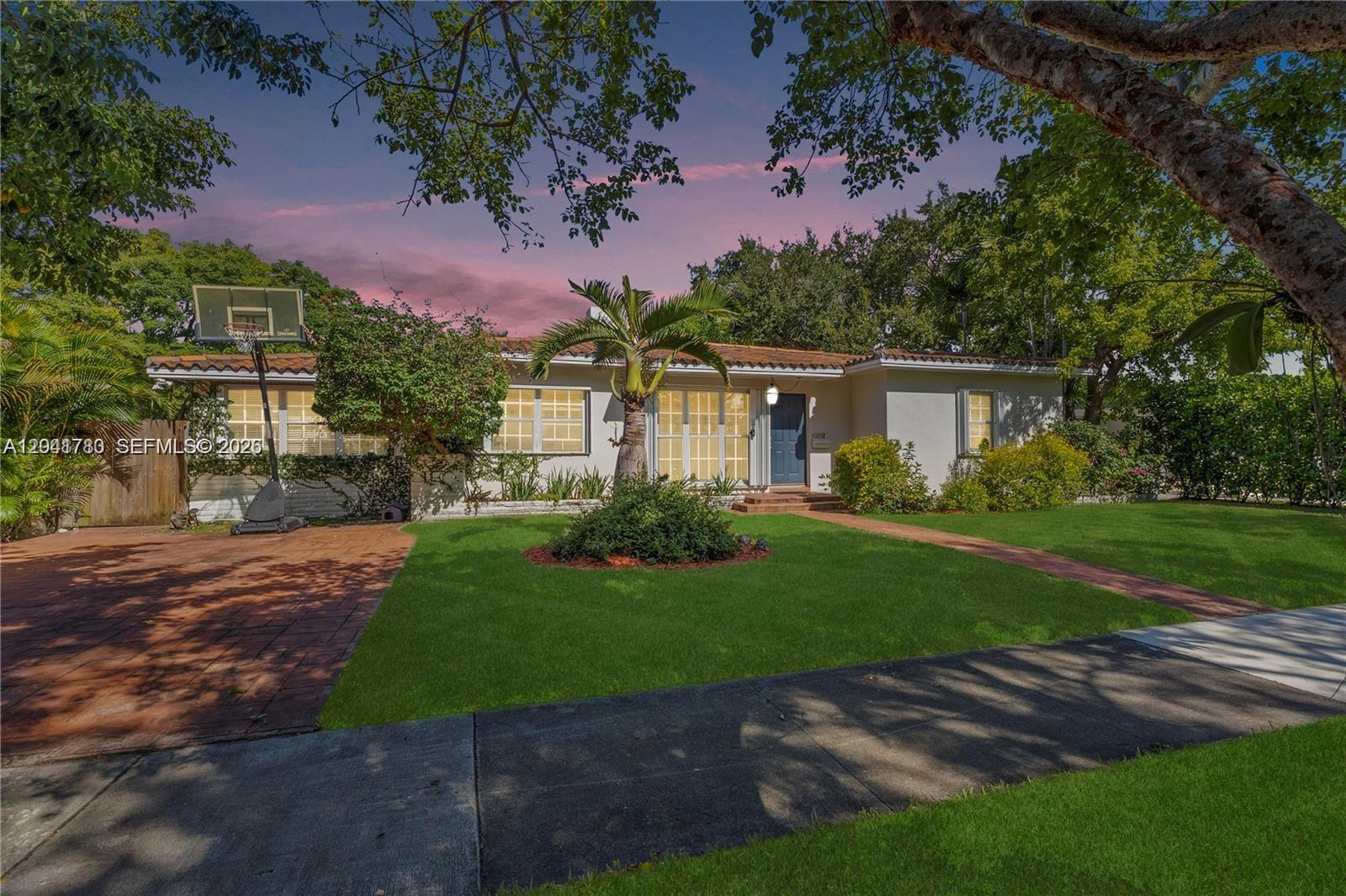 A single-story house with a tiled roof, palm tree, and basketball hoop in the front yard — 1875 Alamanda Dr # 1875, North Miami FL 33181, NORTH MIAMI, FL