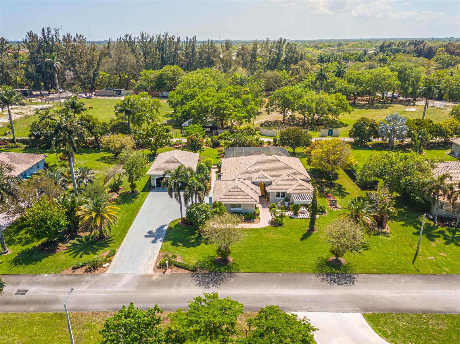 An aerial view shows a single-story house with a tile roof, driveway, and large yard — 5970 SW 55th Street, Davie FL 33314, DAVIE, FL