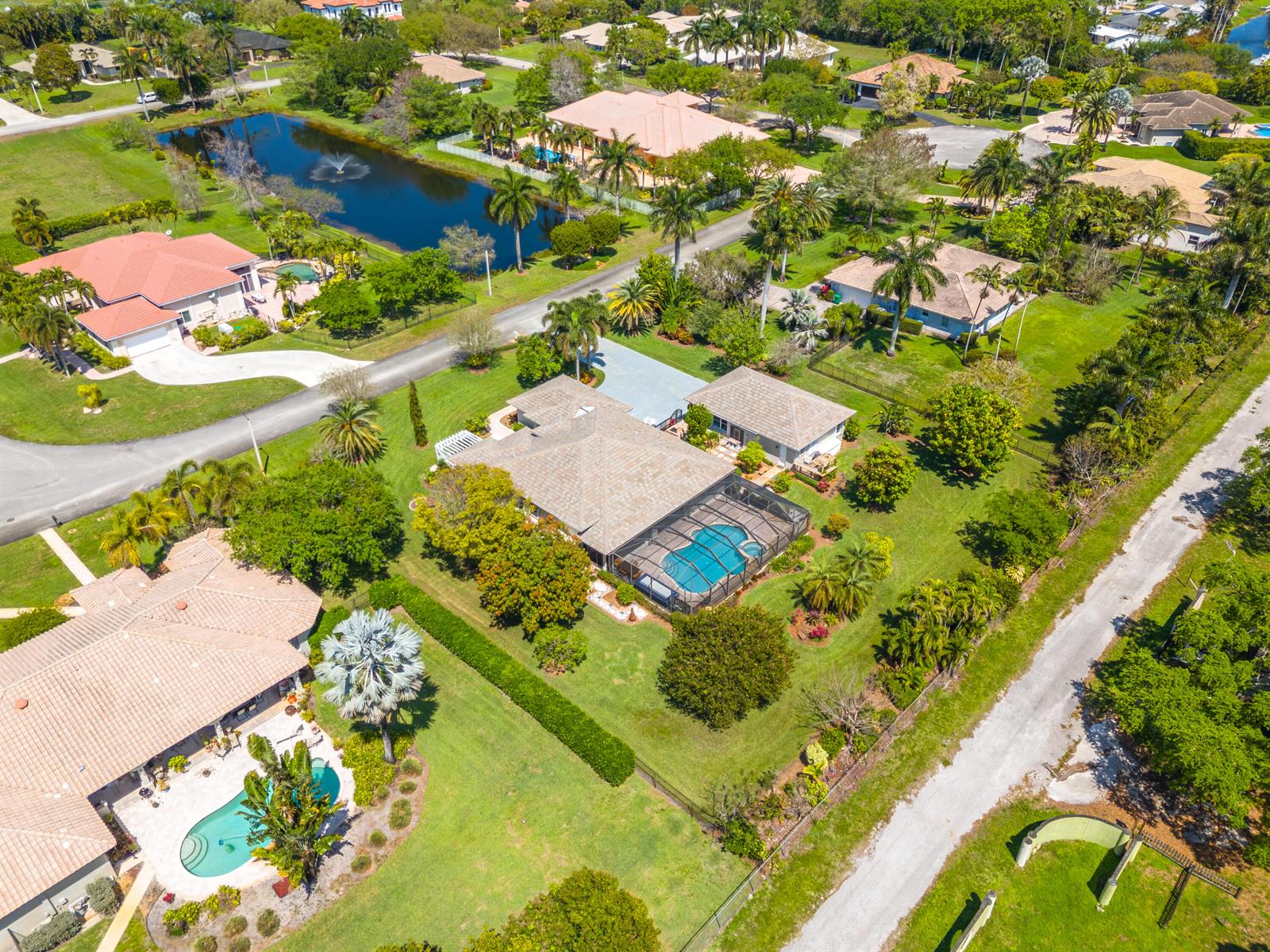 An aerial view shows several suburban houses with swimming pools and lush landscaping — 5970 SW 55th Street, Davie FL 33314, DAVIE, FL