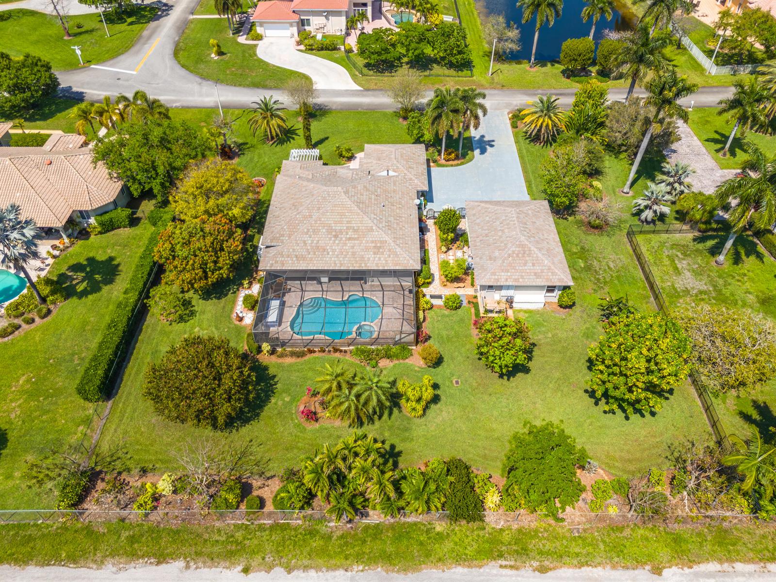 An aerial view shows a house with a screened pool, detached garage, and landscaped yard — 5970 SW 55th Street, Davie FL 33314, DAVIE, FL