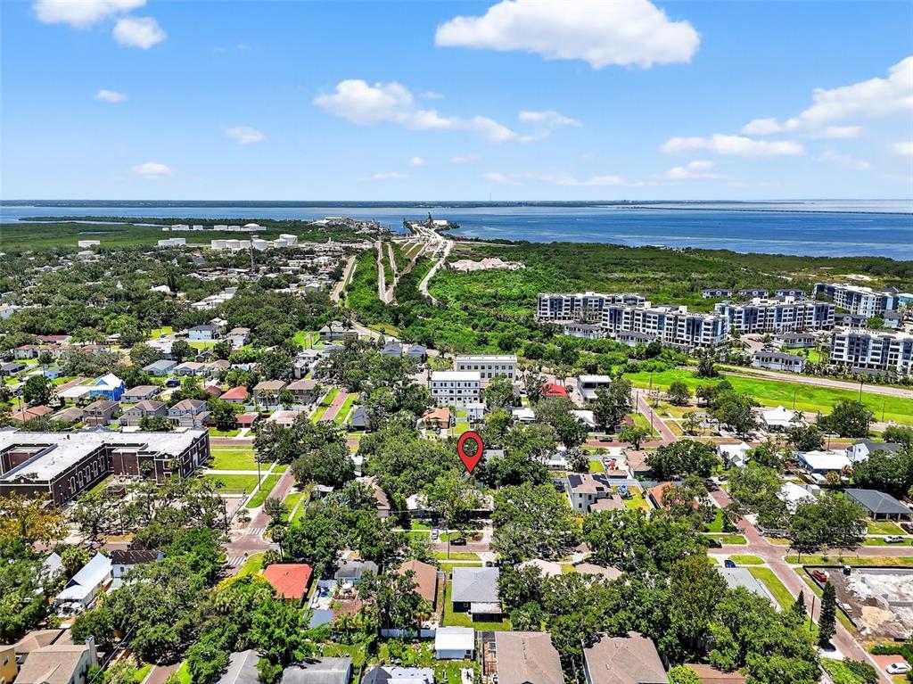 An aerial view shows a residential neighborhood with a red pin marking a specific house — 7009 S FITZGERALD STREET, TAMPA, FL