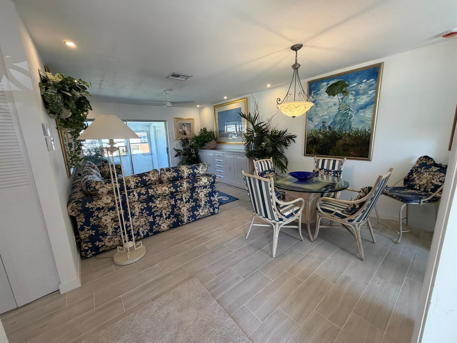 A living and dining area features floral upholstery, a glass-topped table, and light tile flooring — 2747 E Dudley Dr Drive E # D, West Palm Beach FL 33415, WEST PALM BEACH, FL