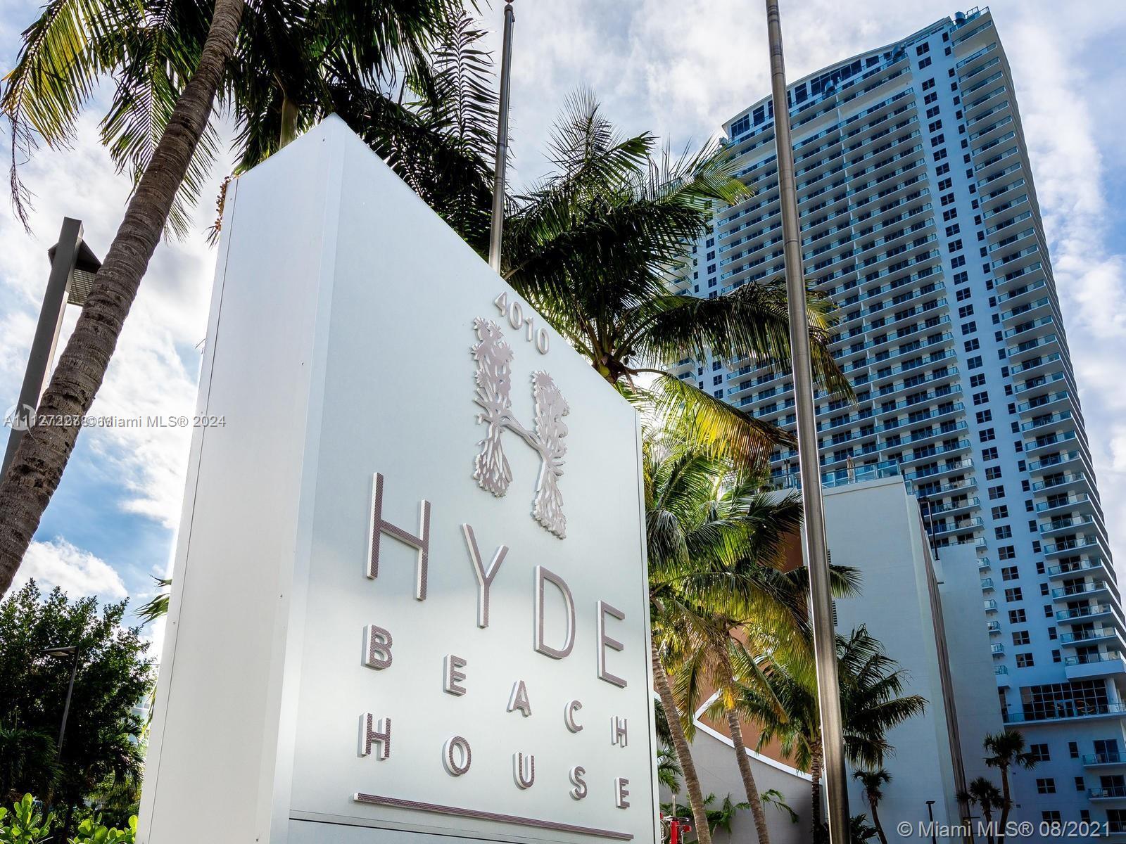 A white sign for Hyde Beach House stands in front of a tall residential building — 4010 S Ocean Dr # R401, Hollywood FL 33019, HOLLYWOOD, FL