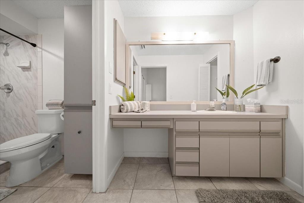 A bathroom features a vanity with light-colored cabinets, a large mirror, and a toilet — 2925 N RIVERS EDGE BOULEVARD UNIT 2925, CRYSTAL RIVER, FL