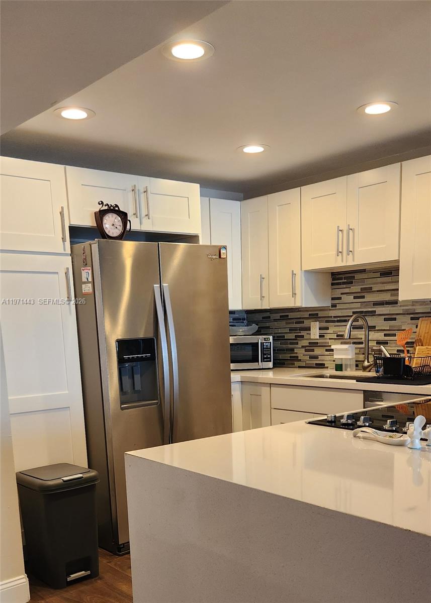 A modern kitchen features white cabinetry, stainless steel appliances, and a white quartz island — 1000 Parkview Dr # 1026, Hallandale Beach FL 33009, HALLANDALE BEACH, FL