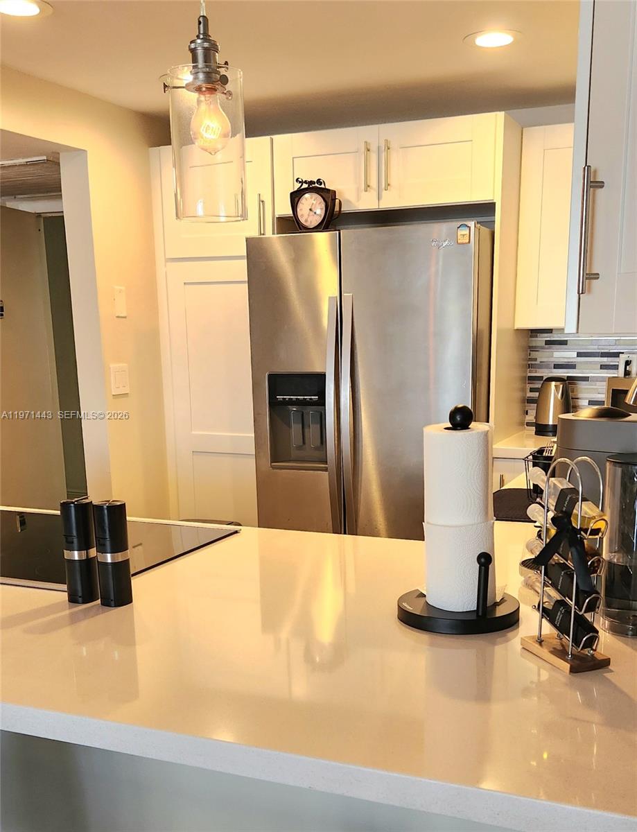 A kitchen features white cabinets, stainless steel appliances, and a light-colored countertop — 1000 Parkview Dr # 1026, Hallandale Beach FL 33009, HALLANDALE BEACH, FL