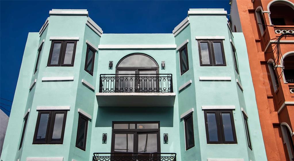 A light green, multi-story building features a central balcony with a black metal railing — 319 RECINTO SUR STREET UNIT 5, SAN JUAN, PR