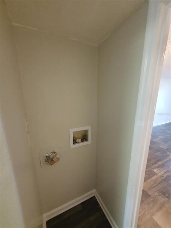 A small laundry closet features plumbing hookups and a recessed wall box for a dryer vent — 1907 ORANGE BOULEVARD WAY, PALM HARBOR, FL