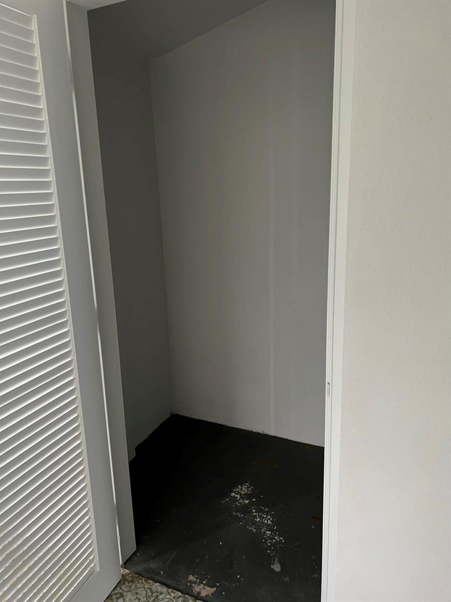 A small, empty closet with white walls and a dark floor — 2736 Dudley Drive E # I, West Palm Beach FL 33415, WEST PALM BEACH, FL