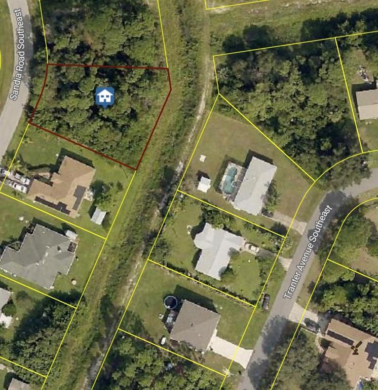 This aerial map shows a vacant, wooded lot outlined in red next to residential homes — 1979 SANDIA ROAD SE, PALM BAY, FL