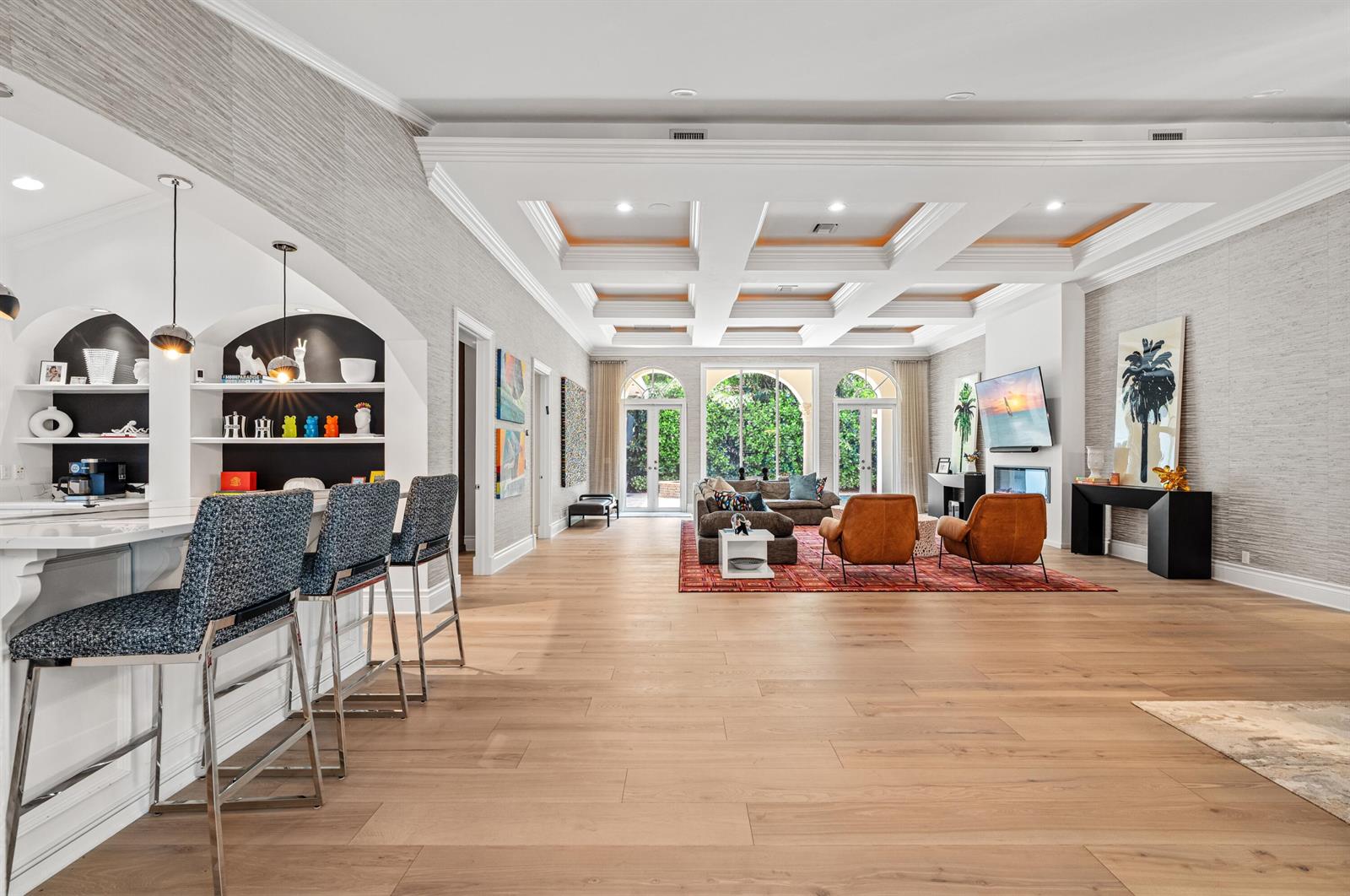 A spacious living room with a coffered ceiling, hardwood floors, and an adjacent kitchen bar — 1098 Spanish River Road, Boca Raton FL 33432, BOCA RATON, FL