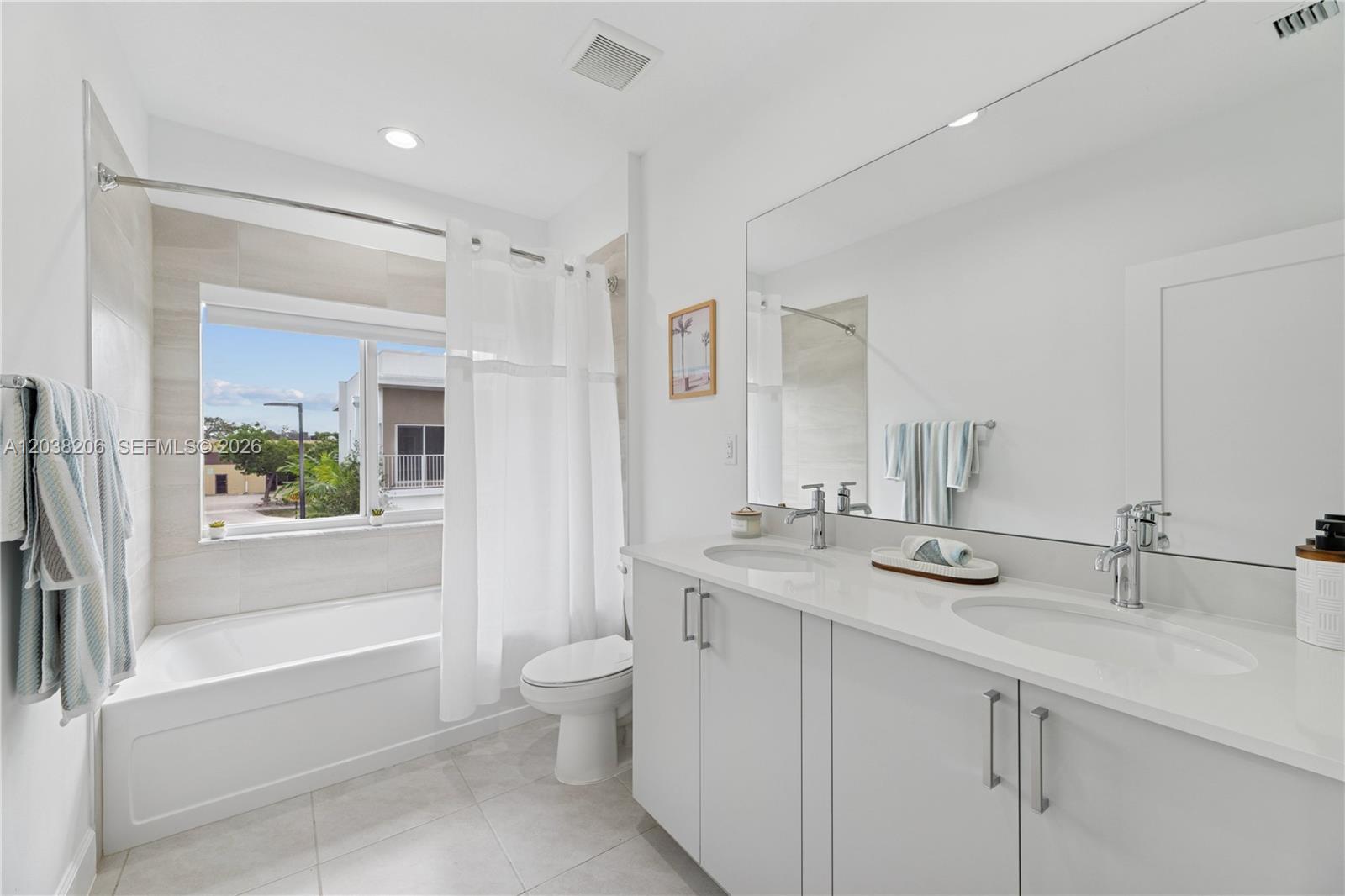 A modern bathroom features a double vanity, a soaking tub with a shower, and tile flooring — 635 NW 30 terrace, Pompano Beach FL 33069, POMPANO BEACH, FL