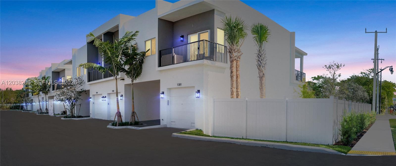 A row of modern two-story townhomes with white stucco exteriors and attached garages at dusk — 635 NW 30 terrace, Pompano Beach FL 33069, POMPANO BEACH, FL