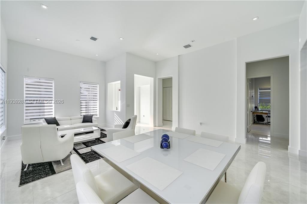 A bright, modern living and dining area features white furniture, tile floors, and recessed lighting — 4919 Frattinas # 4919, Ave Maria FL 34142, AVE MARIA, FL