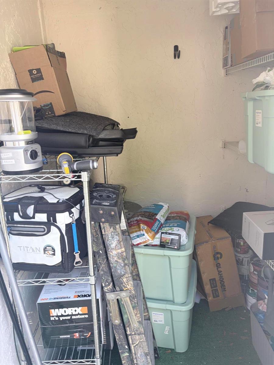 A storage closet contains metal shelving, plastic storage bins, a ladder, and various household items — 3072 Inglewood Terrace, Boca Raton FL 33431, BOCA RATON, FL