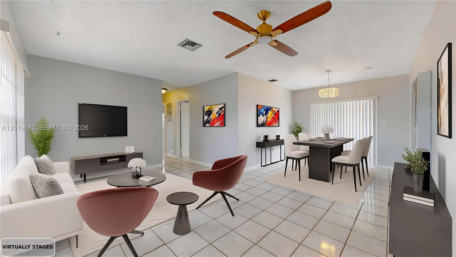 This virtually staged living and dining area features white tile floors and a ceiling fan — 15502 SW 102nd Ave, Miami FL 33157, MIAMI, FL