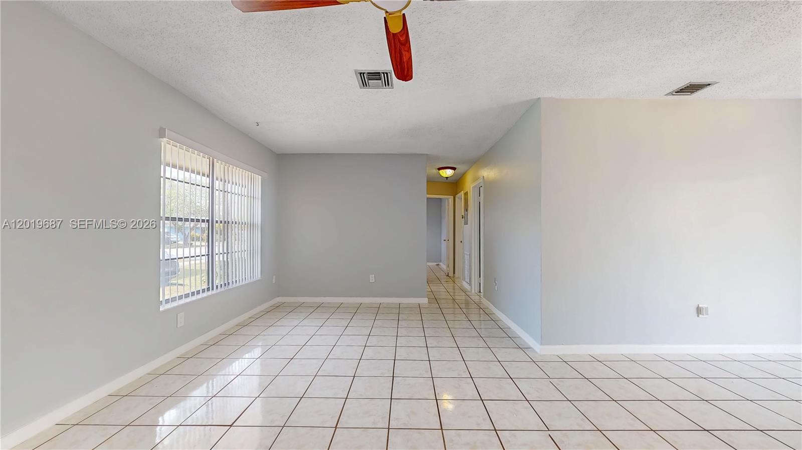 An empty room features light gray walls, white tiled flooring, and a ceiling fan — 15502 SW 102nd Ave, Miami FL 33157, MIAMI, FL