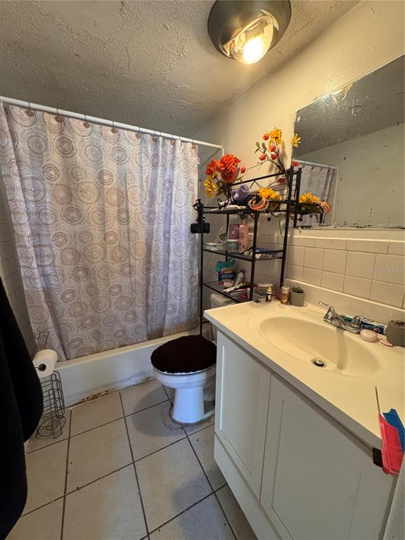 A bathroom features a white vanity, a toilet with a dark cover, and a shower curtain — 1033 COLUMBIA STREET, ORLANDO, FL
