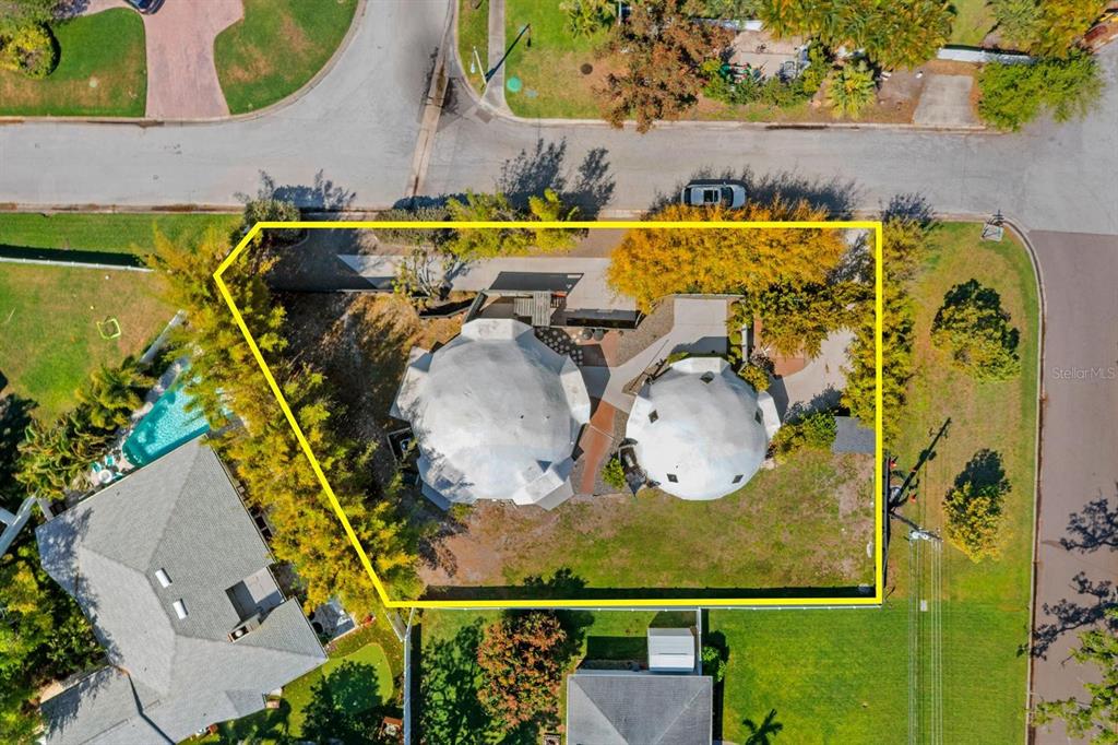 An aerial view shows a residential lot featuring two white geodesic dome structures — 3900 41ST STREET S, ST PETERSBURG, FL