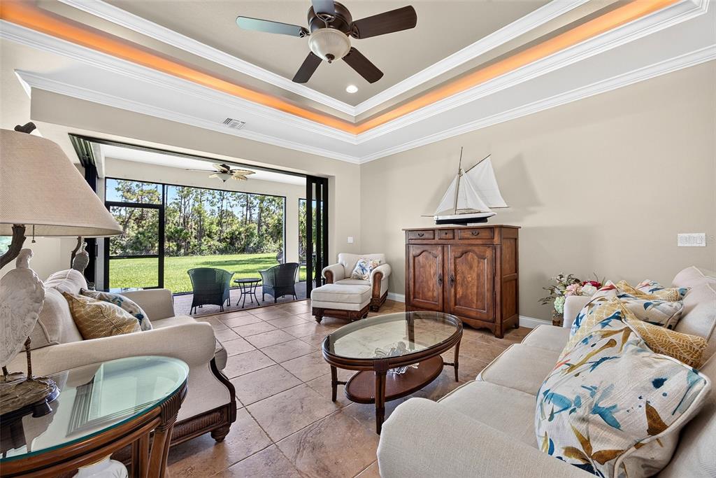 A living room features tile floors, a tray ceiling, and a sliding door to a patio — 3478 WENONA DRIVE, NORTH PORT, FL