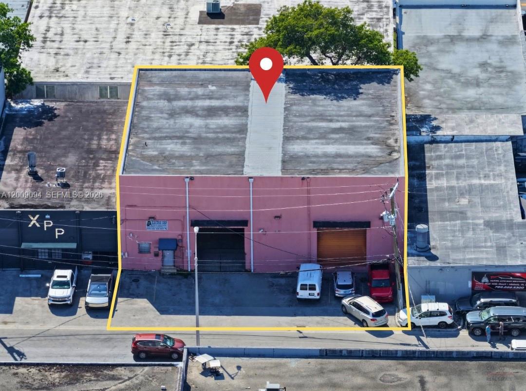 An aerial view shows a pink industrial building with two roll-up doors and parking — 4450 E 10th Ct, Hialeah FL 33013, HIALEAH, FL