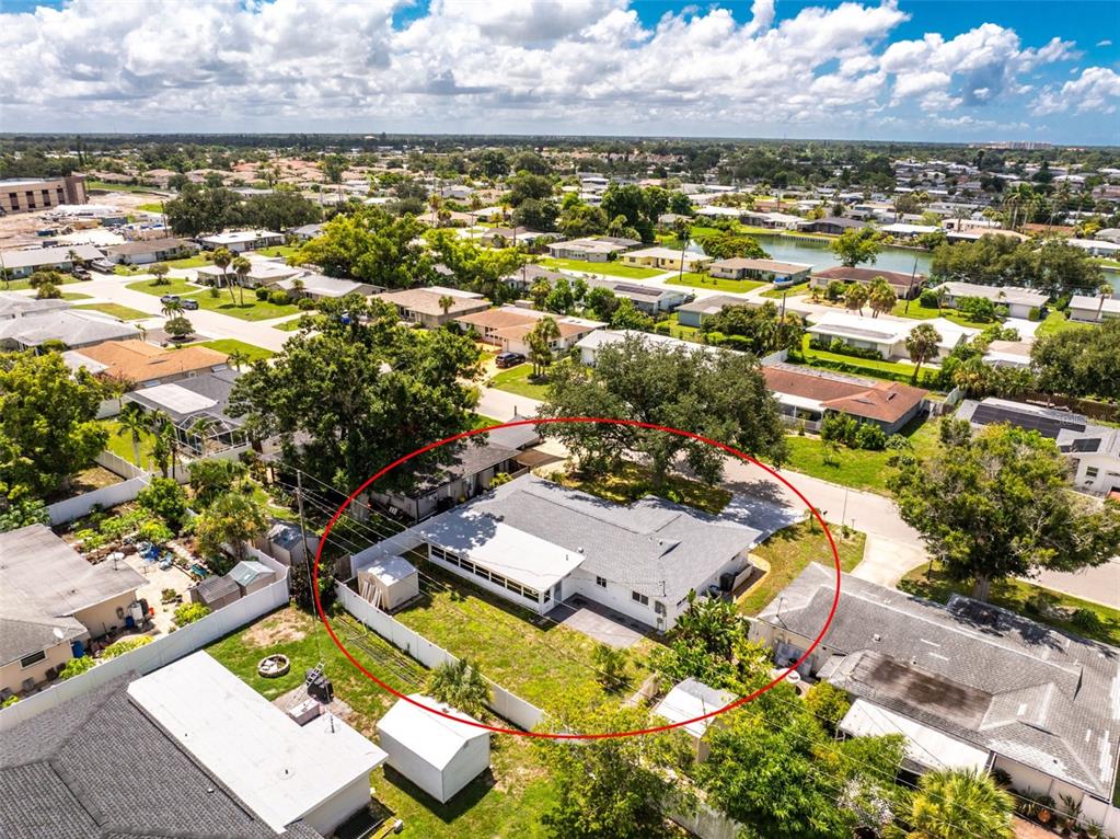 An aerial view shows a single-story house with a white roof and a fenced backyard — 559 MOUNT VERNON DRIVE, VENICE, FL