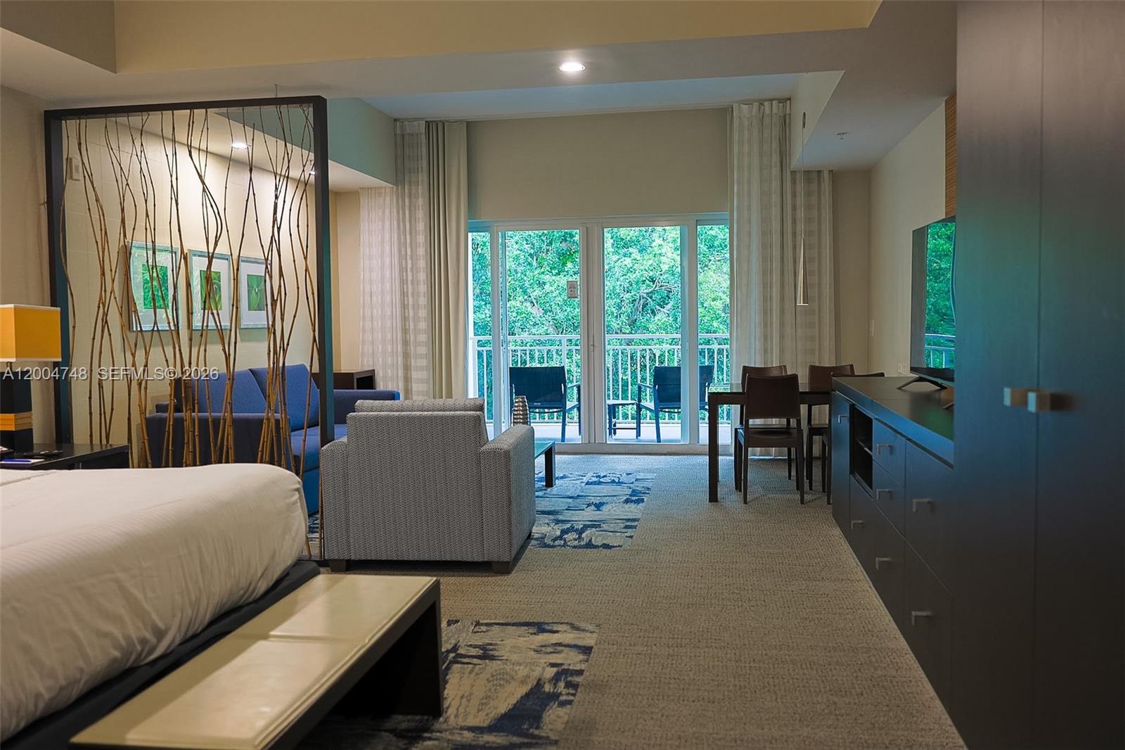 A hotel-style room features a bed, a seating area, a dining table, and a balcony — 5300 NW 87th Ave # 311, Doral FL 33178, DORAL, FL
