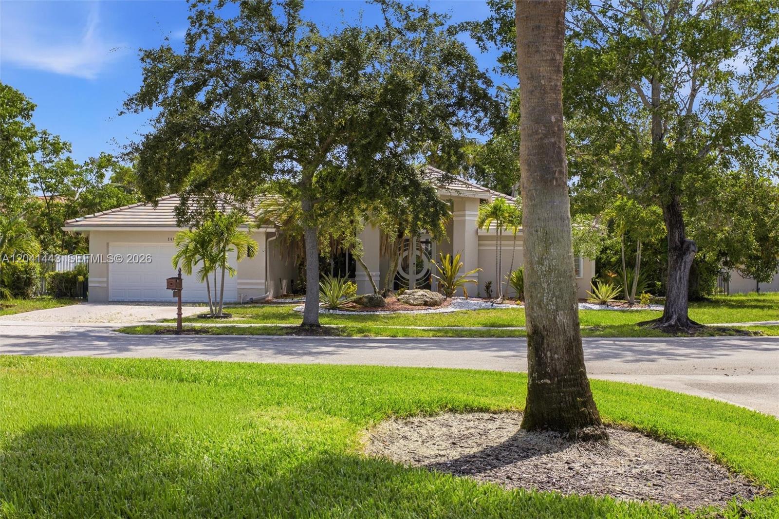 This aerial view shows a house with a swimming pool on a corner lot — 241 Fairmont Way, Weston FL 33326, WESTON, FL