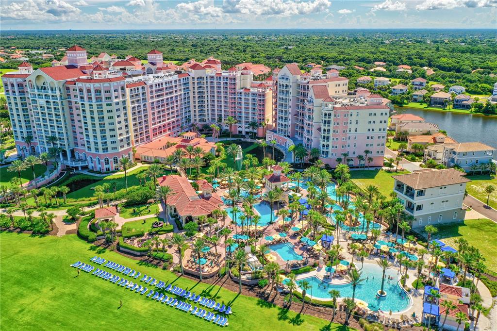An aerial view of a large resort hotel with multiple pools and surrounding green space — 200 OCEAN CREST DRIVE UNIT 635, PALM COAST, FL