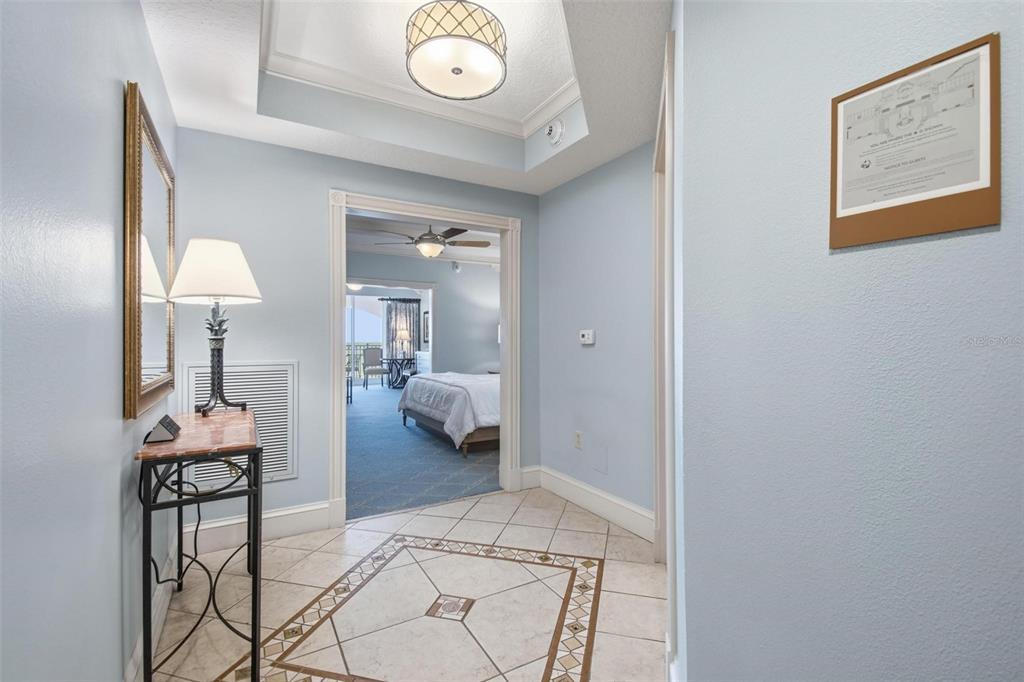 A tiled entryway leads into a bedroom with a view of a balcony — 200 OCEAN CREST DRIVE UNIT 635, PALM COAST, FL