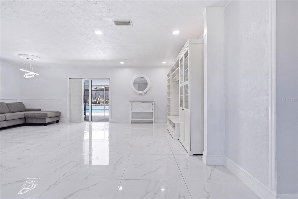 A light blue brick ranch-style house features dark shutters, a white garage, and a lawn — 1124 KING ARTHUR COURT, VALRICO, FL