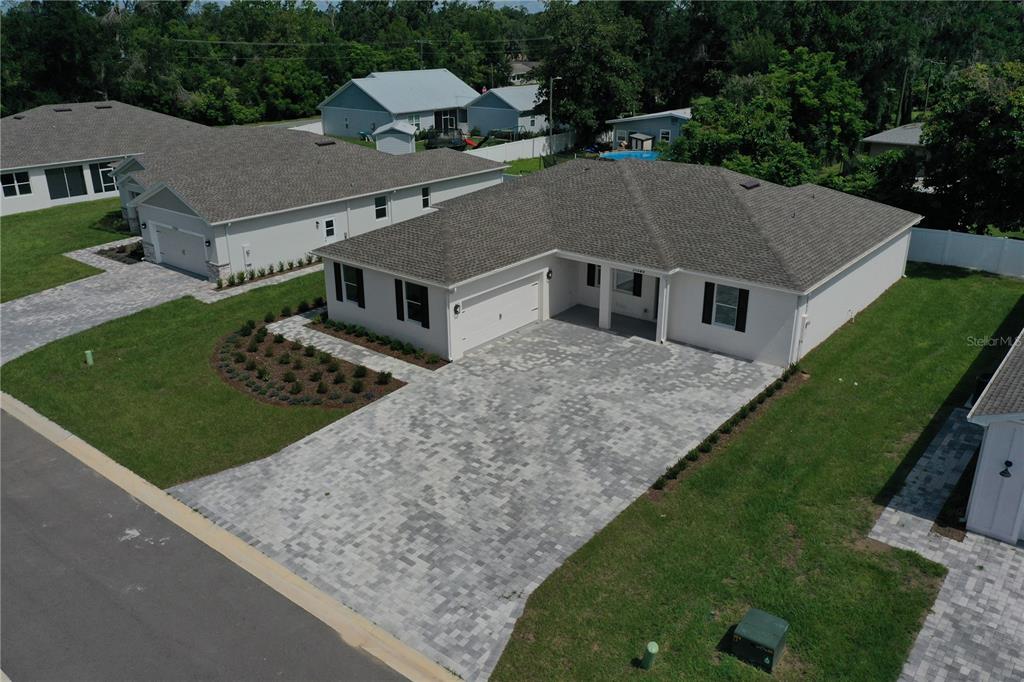 An aerial view of a single-story house with a paved driveway and a landscaped yard — 37549 TERI COURT, DADE CITY, FL