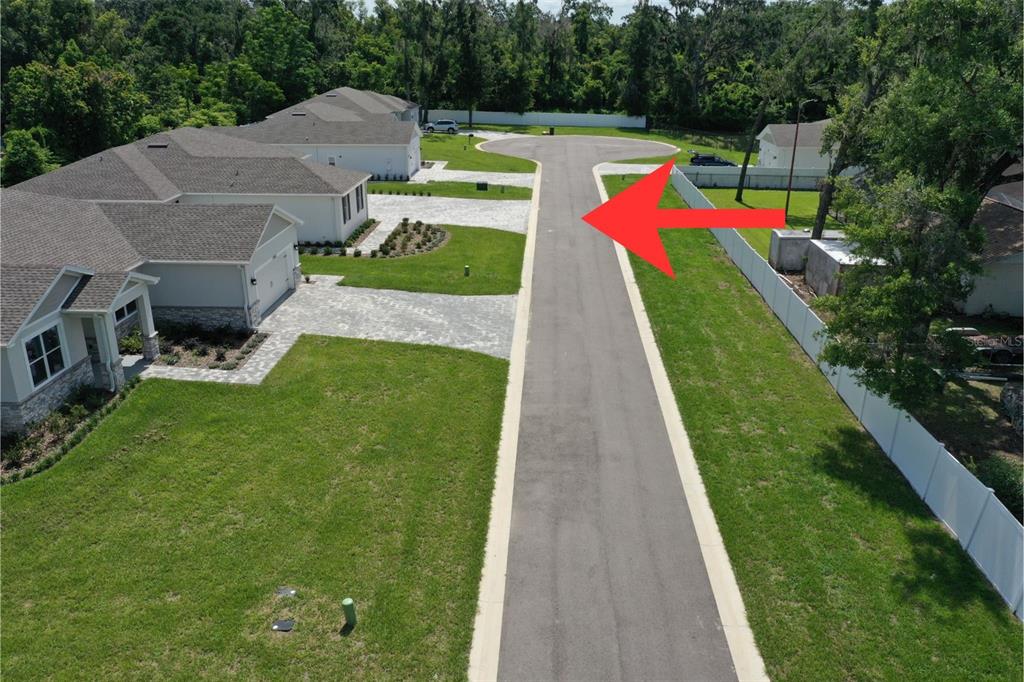 An aerial view shows a paved residential street leading to a cul-de-sac near several houses — 37549 TERI COURT, DADE CITY, FL