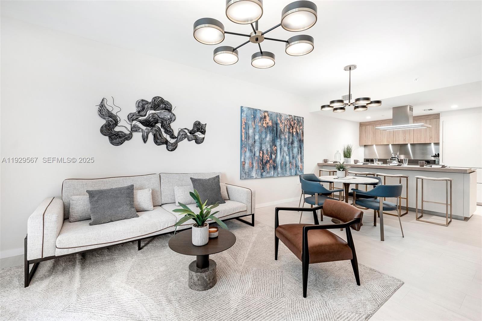 This open-concept living and dining area features modern furniture, contemporary light fixtures, and neutral finishes — 1000 Brickell Plz # 4005, Miami FL 33131, MIAMI, FL
