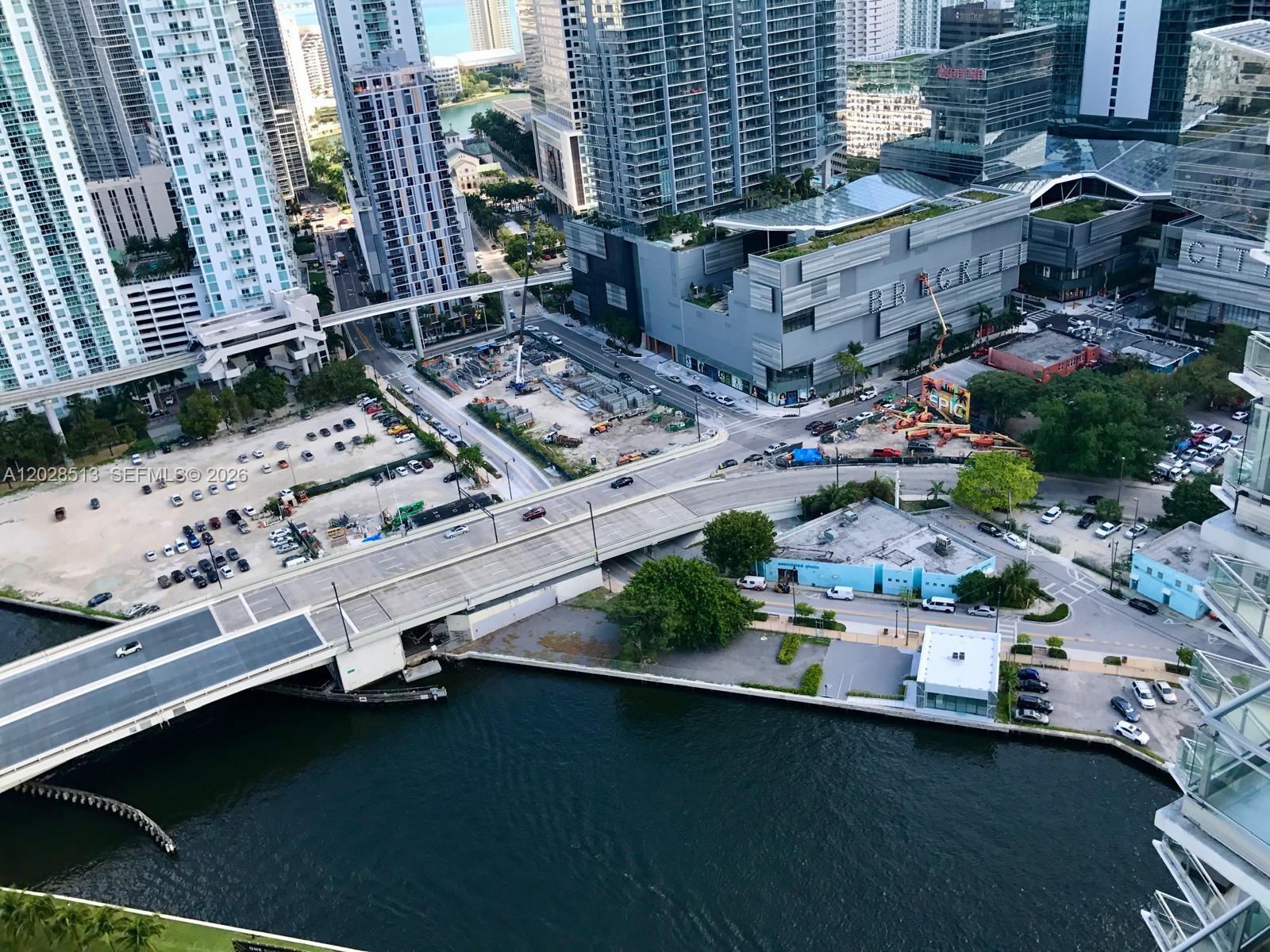 An aerial view shows a city waterfront with a bridge, parking lots, and skyscrapers — 92 SW 3rd St # 3712, Miami FL 33130, MIAMI, FL