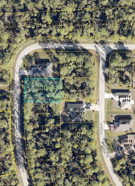 This is an aerial map showing a vacant lot highlighted in blue within a residential neighborhood — BADOSA ROAD, NORTH PORT, FL