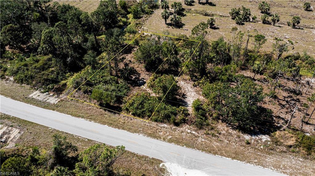 An aerial view shows a rectangular plot of land outlined in yellow next to a road — 12539 GREEN GULF BOULEVARD, PUNTA GORDA, FL