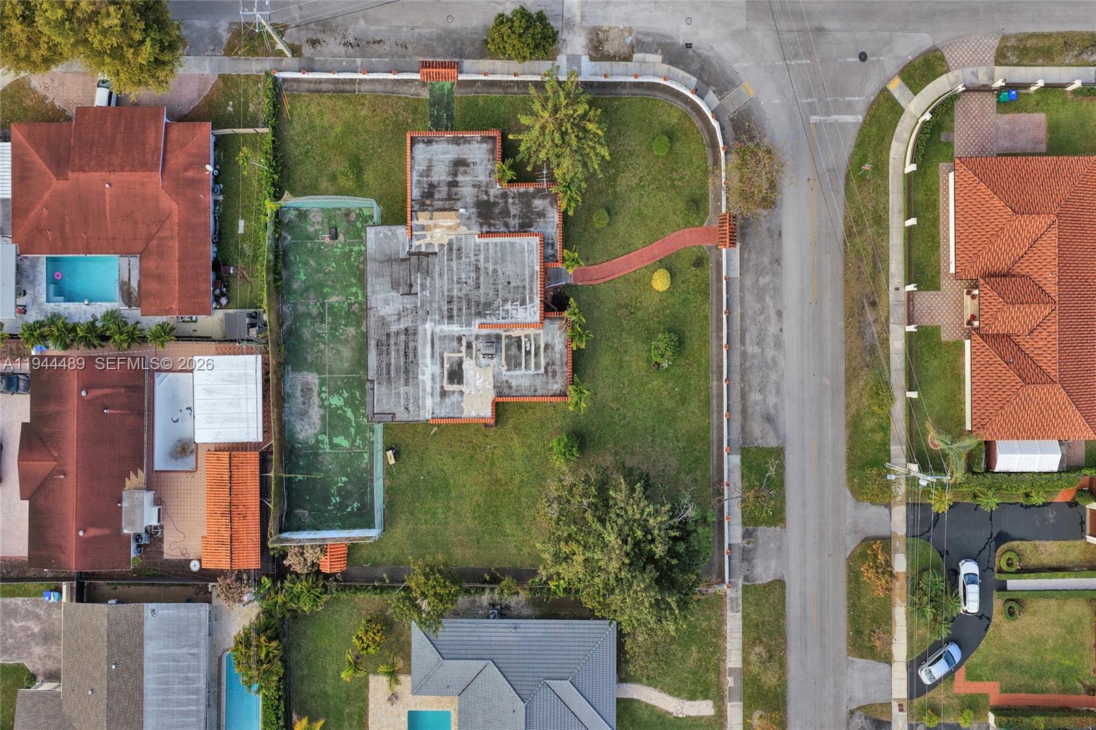 An aerial view shows a house with a tennis court and large yard — 500 SW 39th Ct, Miami FL 33134, MIAMI, FL