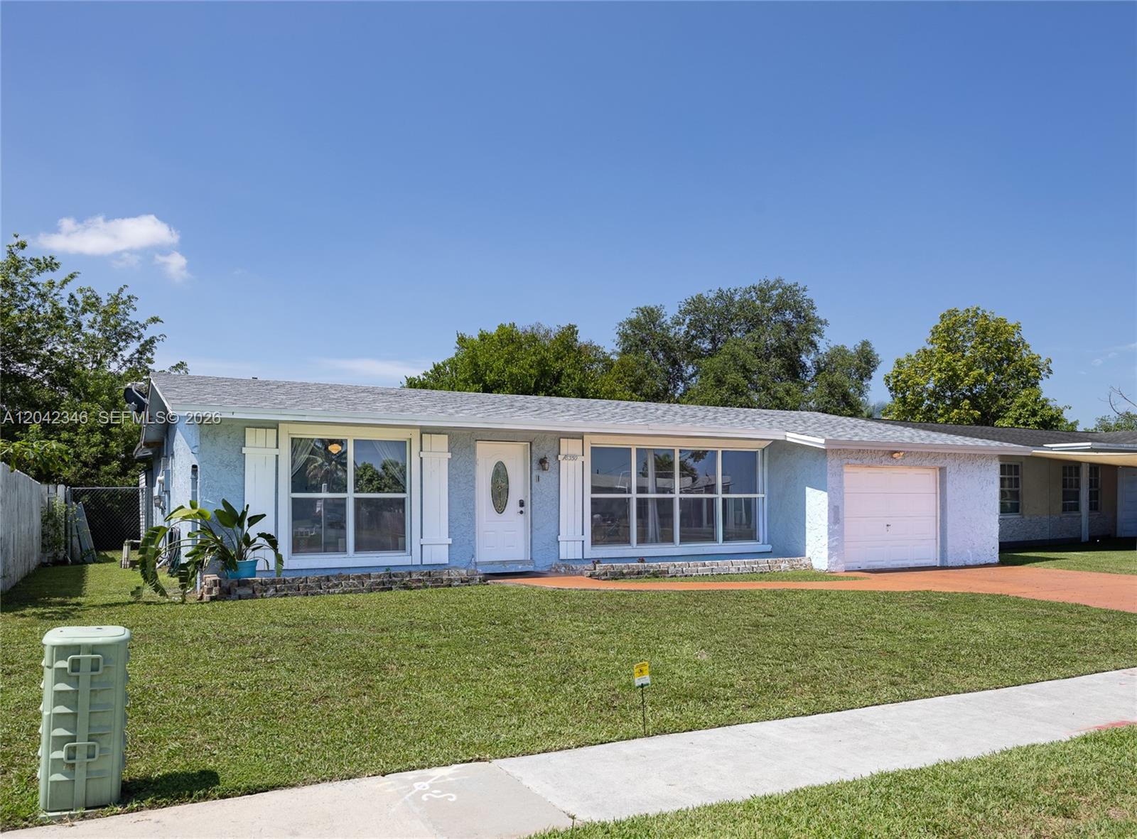 A light blue single-story house with a white front door and an attached garage — 8350 NW 27th Pl, Sunrise FL 33322, SUNRISE, FL