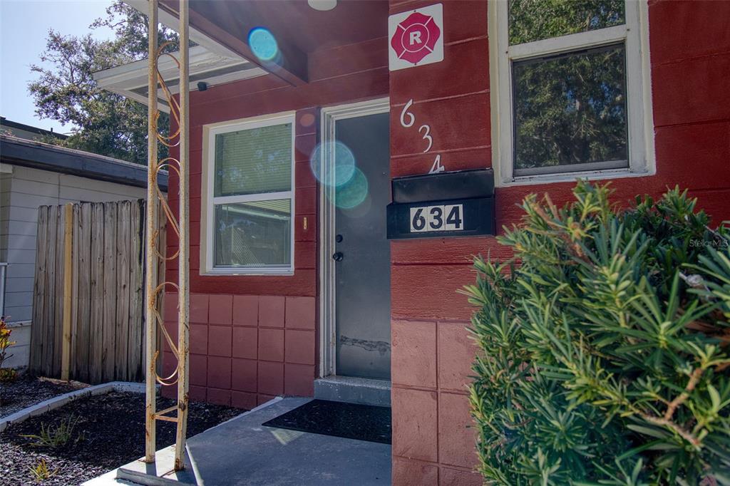 The exterior of a red building features a front door, a window, and a mailbox — 634 15 AVENUE S, ST PETERSBURG, FL