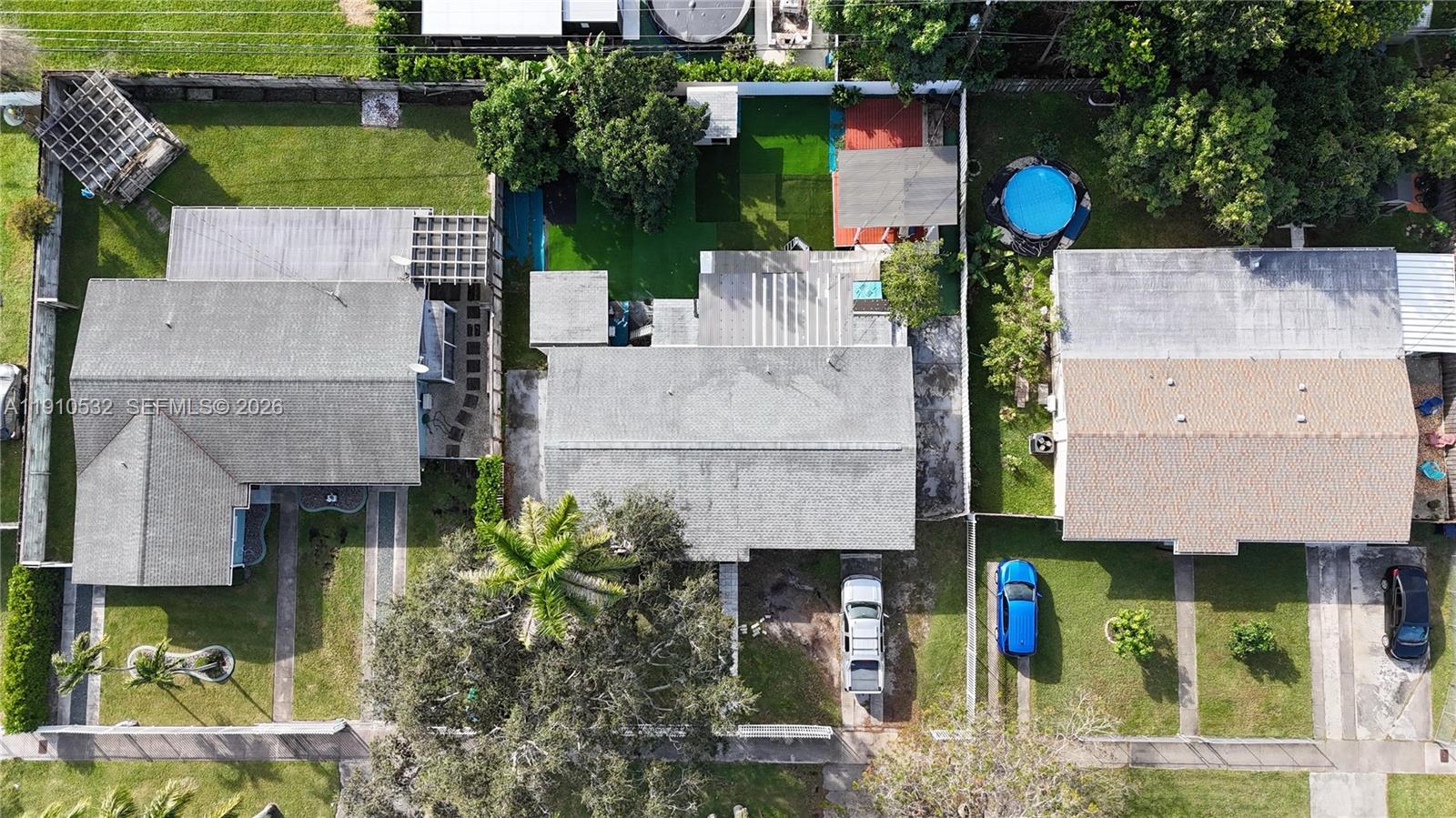 An aerial view shows three residential houses with driveways, backyards, and a small pool — 14800 SW 296th St, Homestead FL 33033, HOMESTEAD, FL