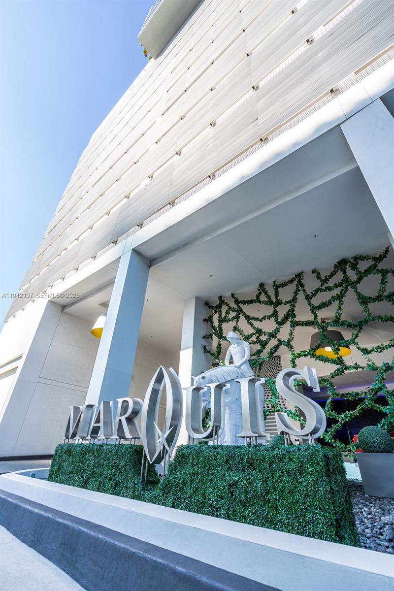 The exterior entrance of the Marquis building features large silver lettering and a statue — 1100 Biscayne Blvd # 2907, Miami FL 33132, MIAMI, FL