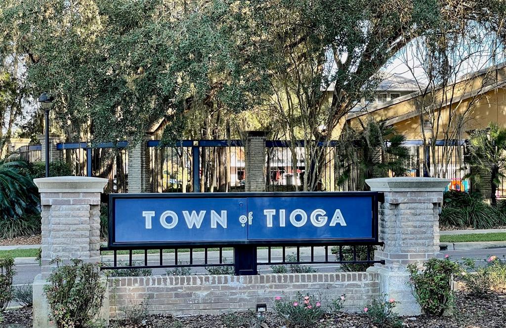 A blue sign reading Town of Tioga stands between two brick pillars under large trees — 1062 SW 135TH DRIVE, NEWBERRY, FL