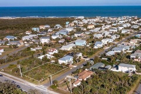 An aerial view shows a vacant, rectangular lot outlined in white near a coastal neighborhood — 6261 N OCEAN SHORE BOULEVARD, PALM COAST, FL