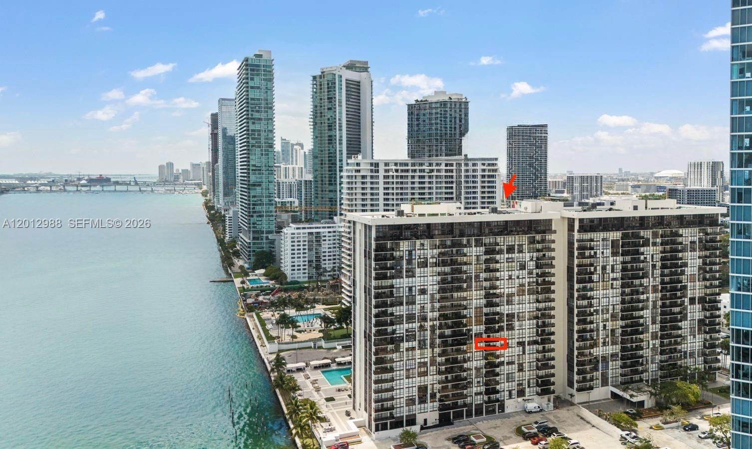 An aerial view shows a high-rise residential building with a red box highlighting a balcony — 600 NE 36th St # 706, Miami FL 33137, MIAMI, FL